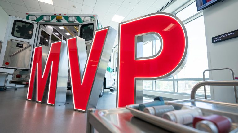 Large MVP letters near ambulance