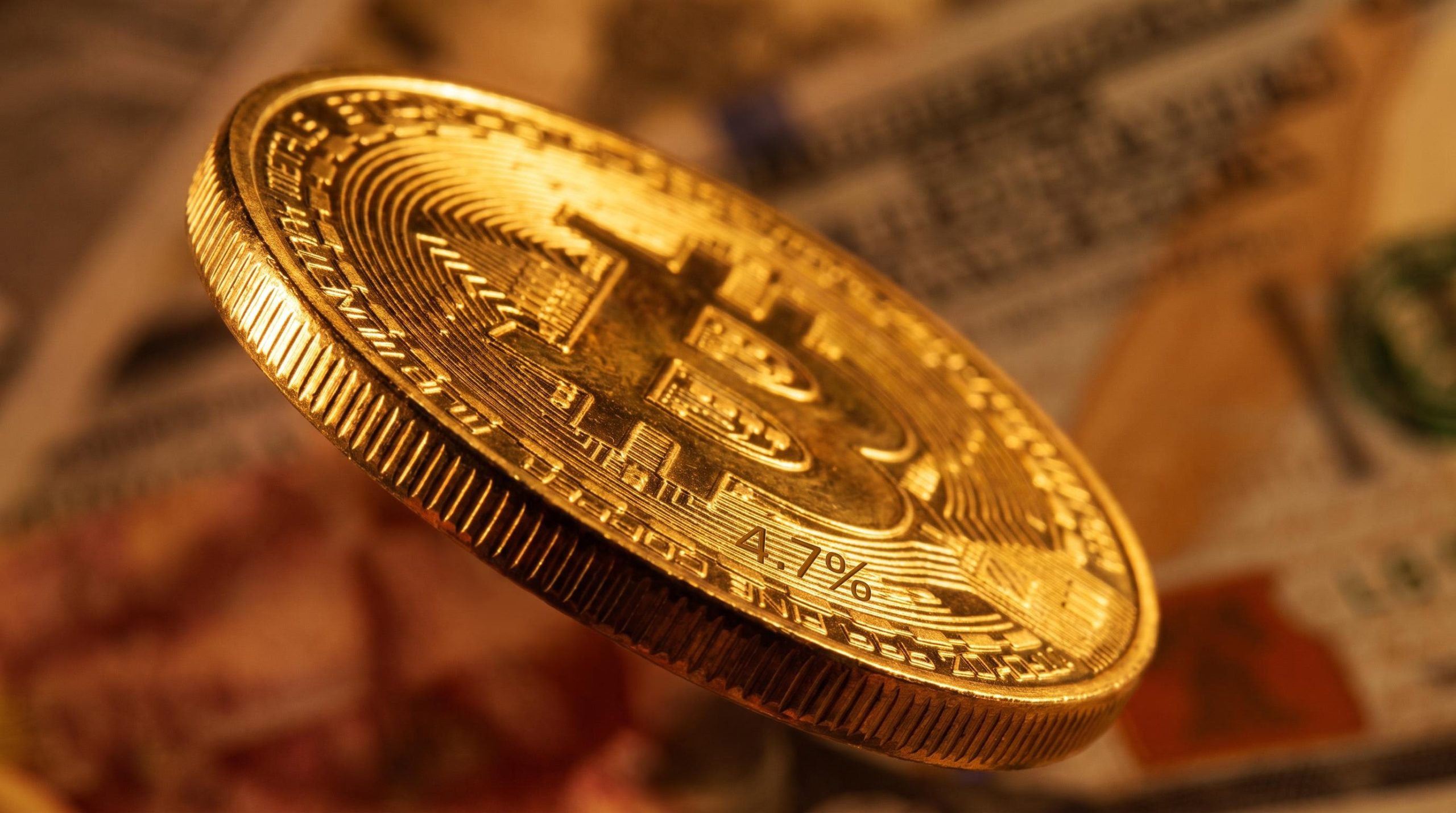 Hyperreal Bitcoin coin with milled edge foregrounded, "4.7%" inflation figure etched into surface against warm amber background