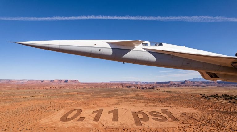 Supersonic aircraft over US desert with 0.11 psf noise threshold etched on cracked earth below