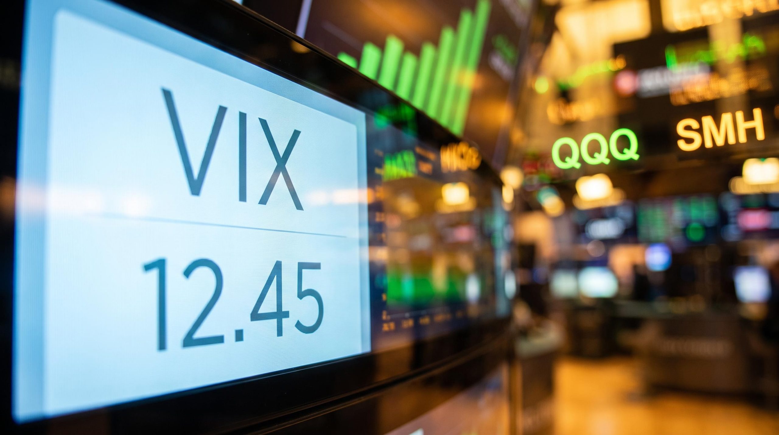 VIX screen shows surface calm while QQQ and SMH volatility surges in reflection — tech options strategy