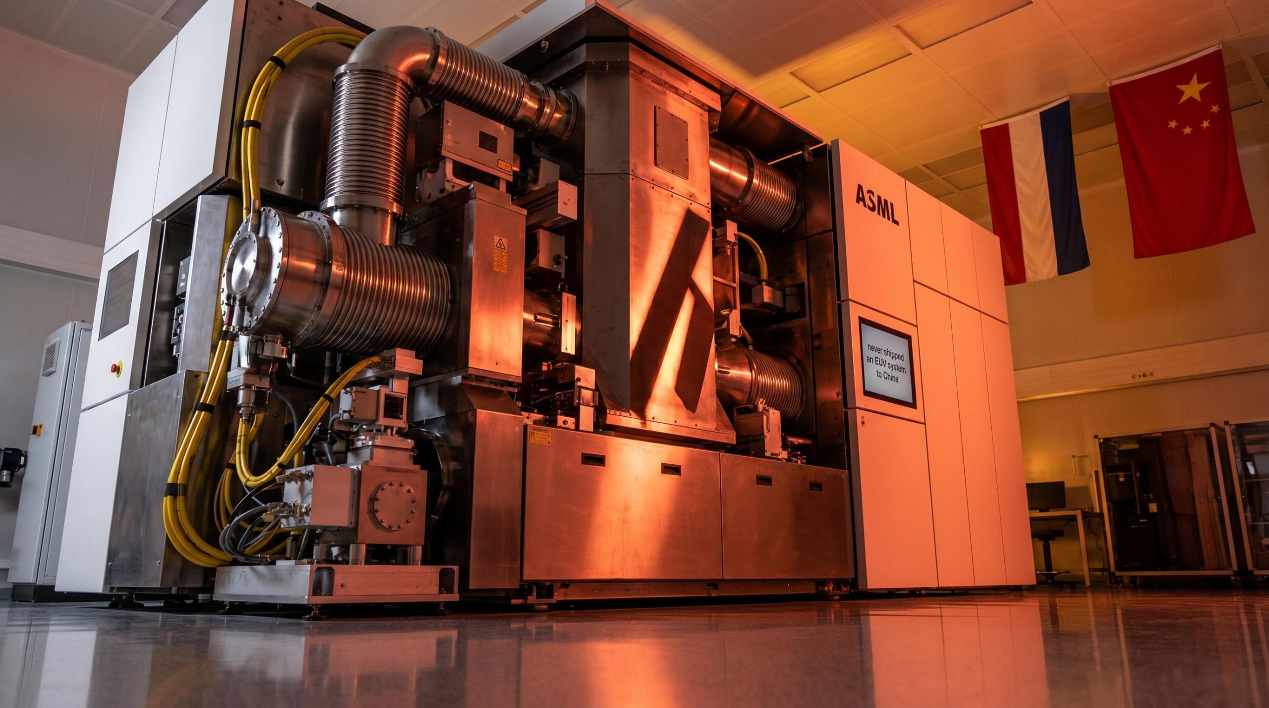 ASML EUV lithography machine under red-amber light with Dutch and Chinese flags amid China export ban controversy